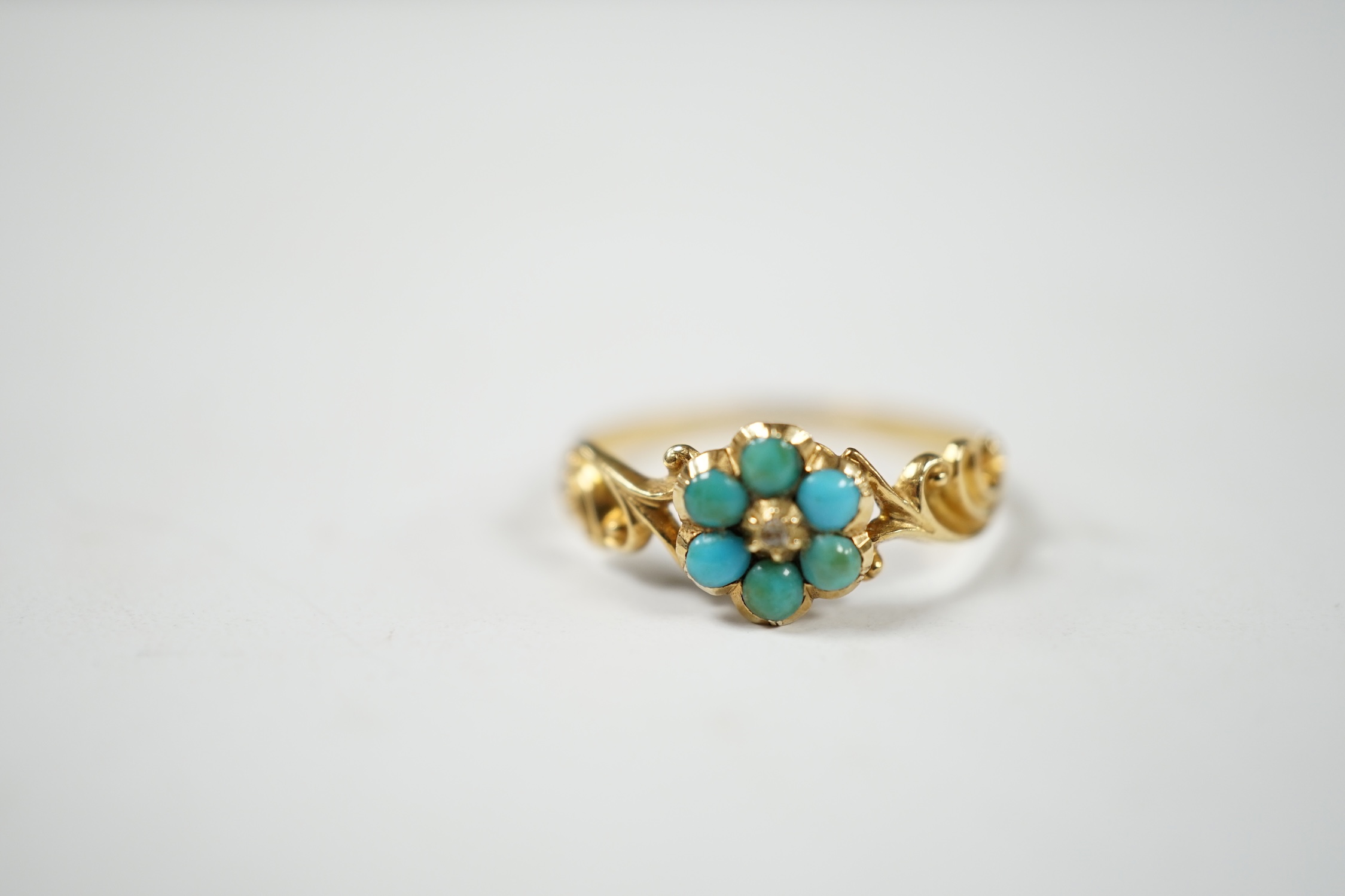 A late Victorian yellow metal, turquoise and rose cut diamond set flower head cluster ring, size L, gross weight 1.4 grams. Condition - fair, band mis-shapen